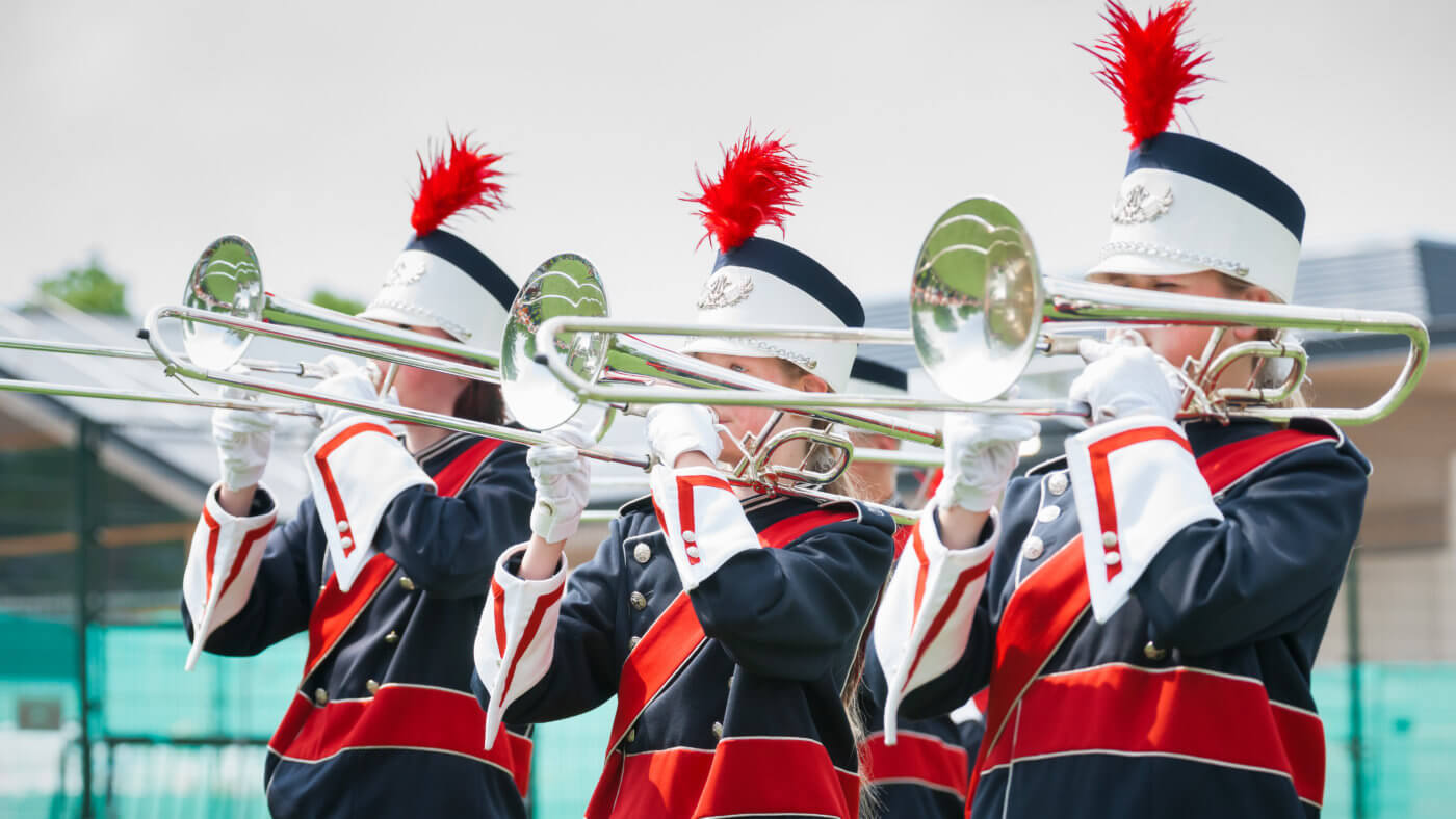 Show band with live music playing wind instruments in uniform